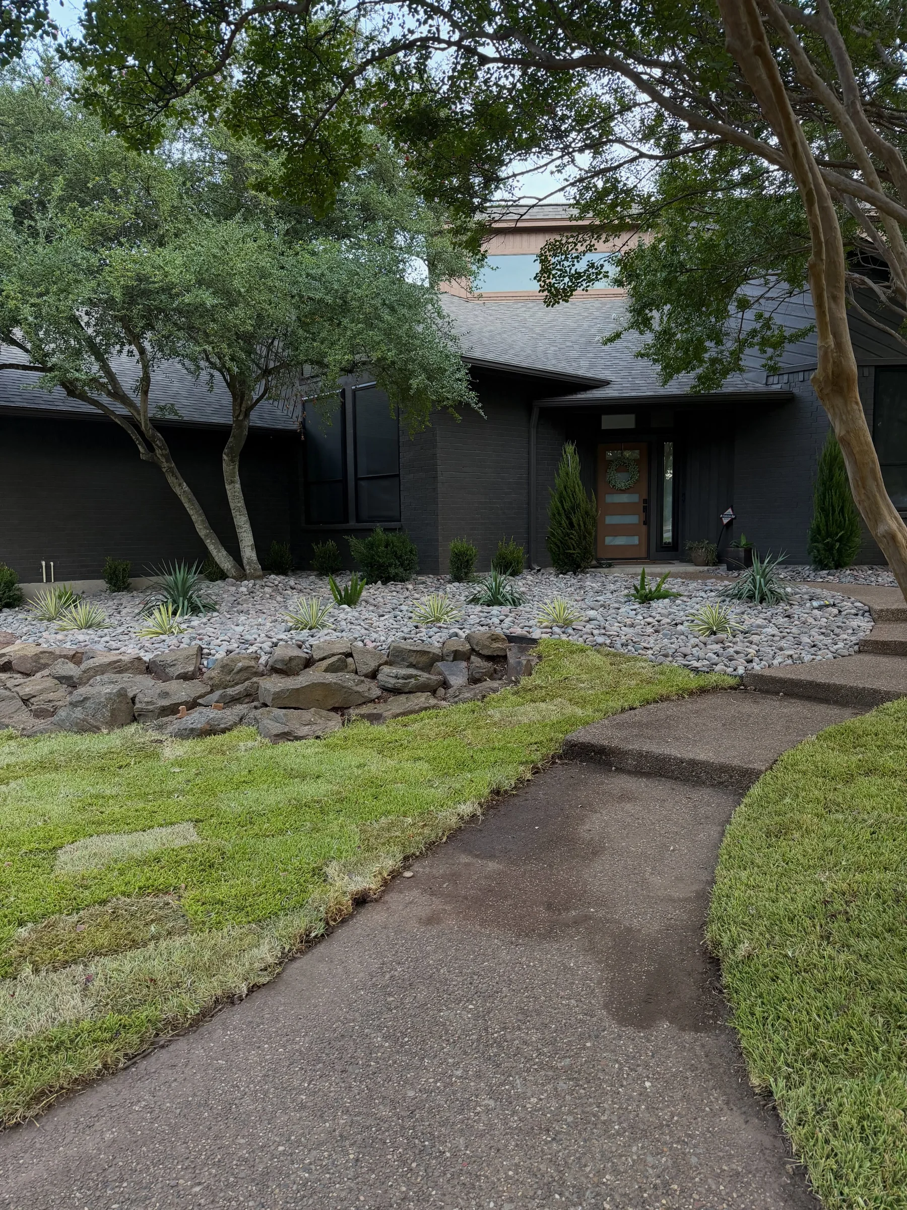 Completed planting and rock beds along the Southlake entry walk
