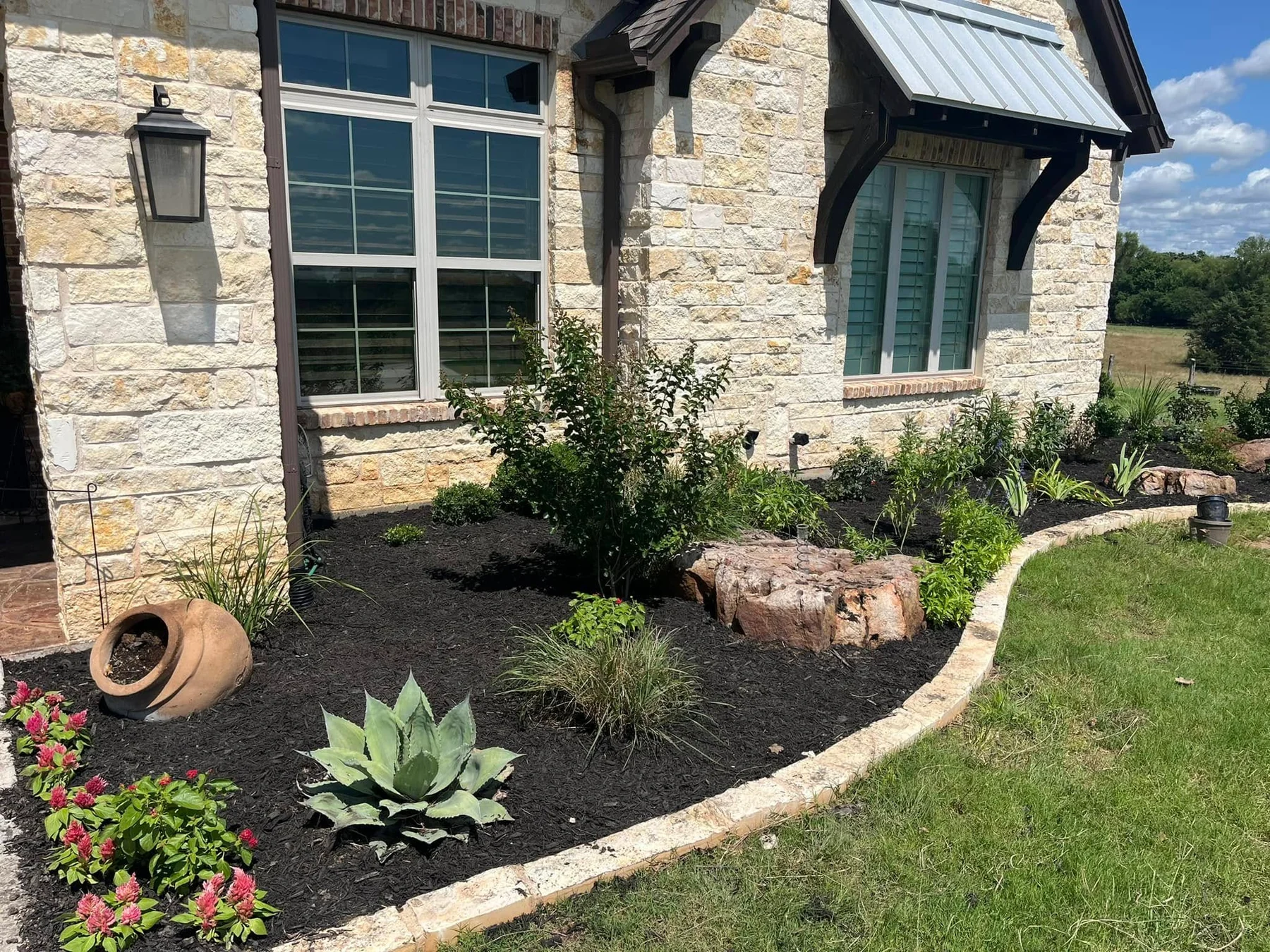 Natural stone and planted beds in a Braziel landscape